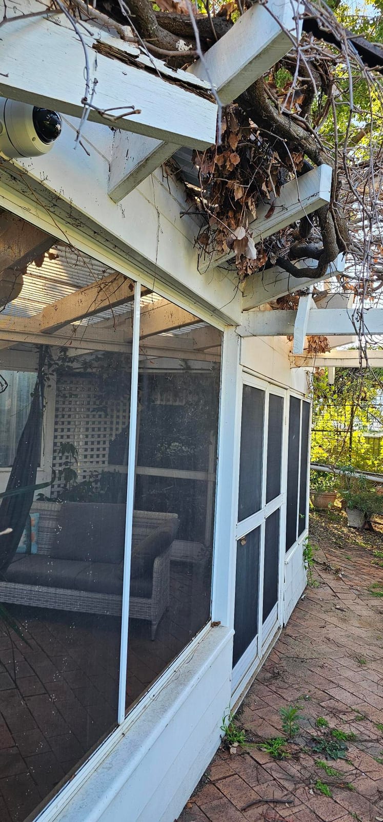 Residential CCTV camera covering a garden-side entry