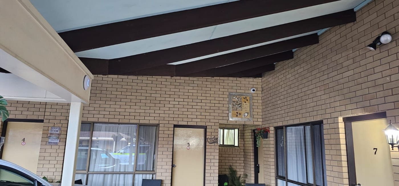 External CCTV camera installed beneath the motel courtyard roof